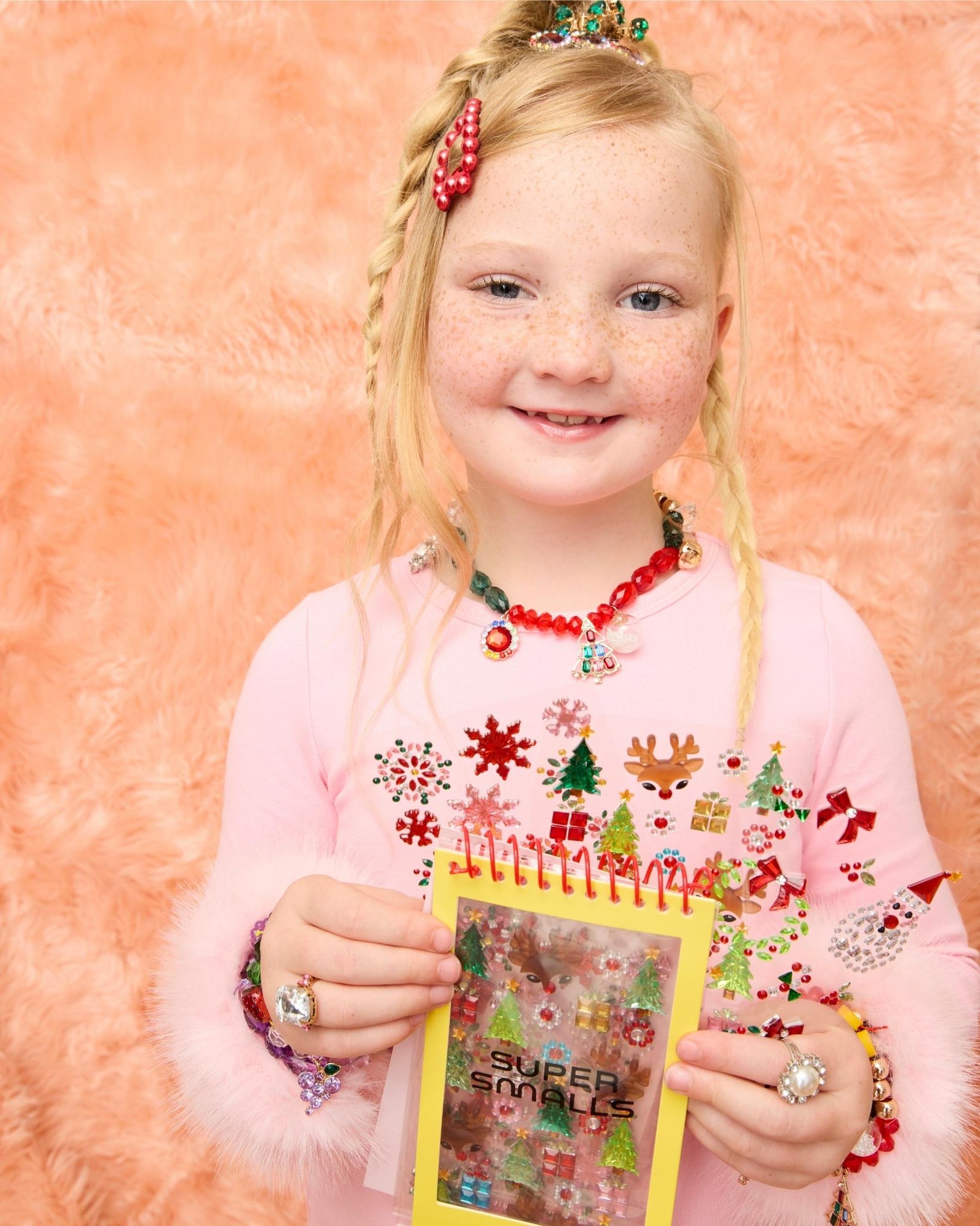 Model showing the christmas themed sticker book for kids